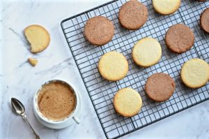 vegan tea biscuits on cooling rack with acoffee on side