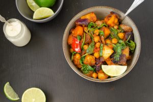 Harissa Roasted root vegetables with chickpeas and spinach served with tahini sauce
